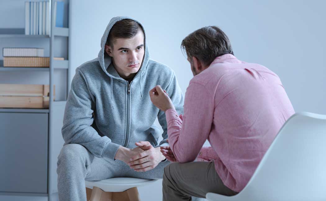 A young man speaks with his doctor about attending treatment at Circle of Hope as the best detox for meth in California